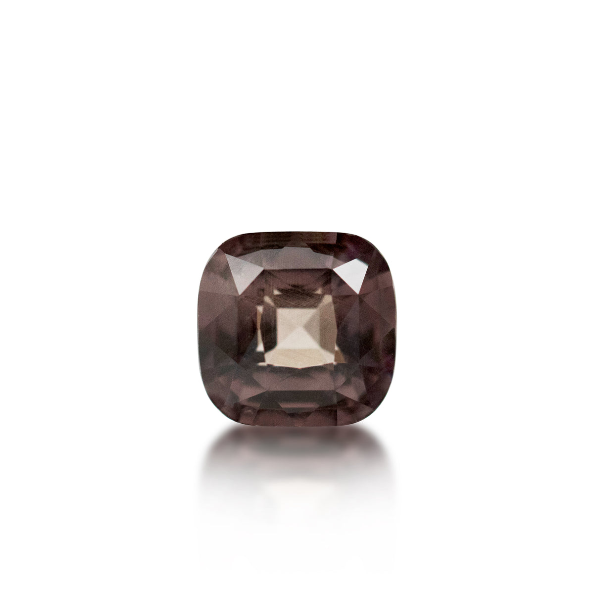 A cushion-cut smoky brown gemstone with a faceted square center, displayed on a clean white background with a soft reflection below.