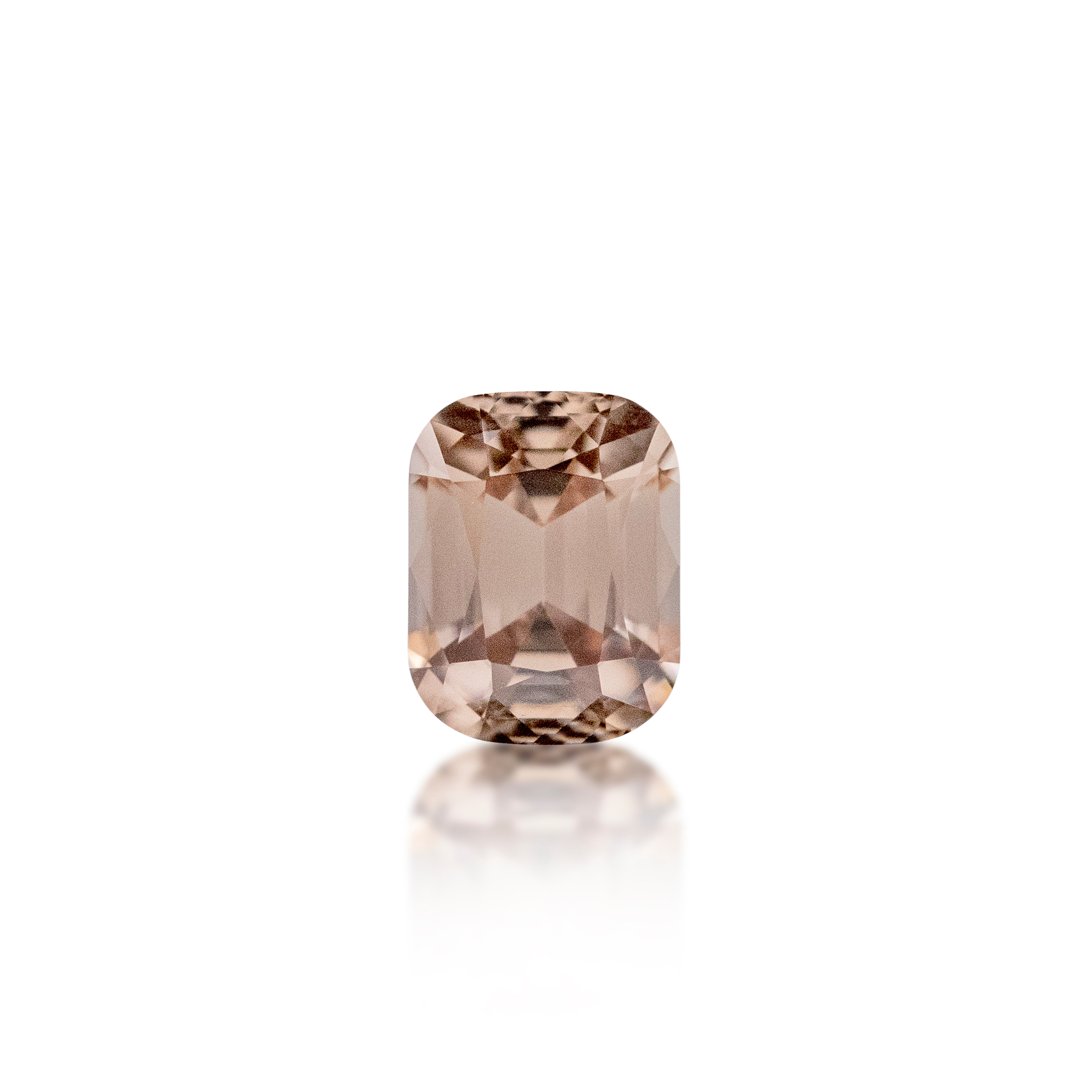 A single cushion-cut emerald-cut zircon gemstone with a soft peach-pink color, displayed on a clean white background with a subtle reflection below.
